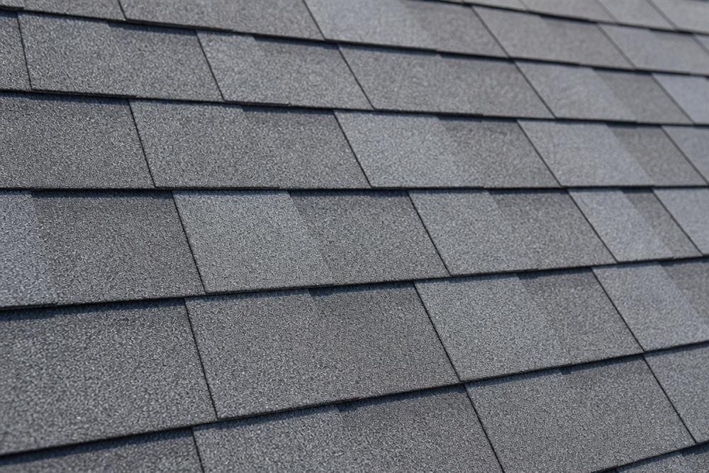 Close-up texture of newly installed grey roof shingles